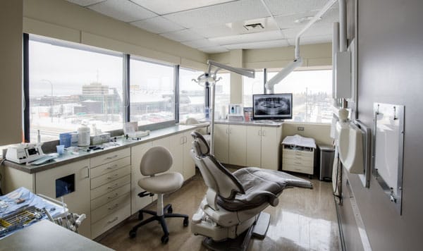 Empty chair with view of city outside of Generations Dental patient room