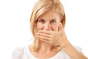 woman covering her mouth
